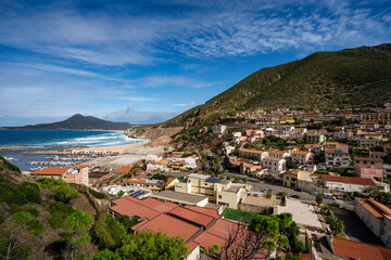 Obraz premium Panoramic view of Buggerru, mining village and marina on the coast of Sardinia, Italy.