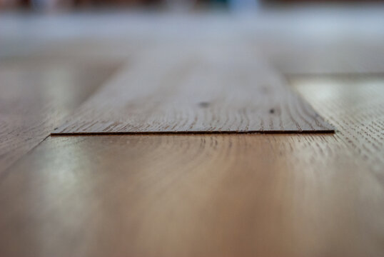 parquet renovation close up with new wooden planks and uneven surface