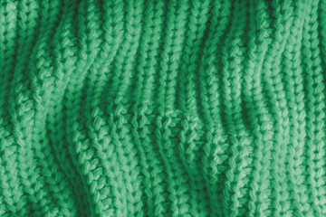 Close up, macro of crumpled green knitted fabric with visible wrinkles, folds and soft waves. Soft wool texture with detailed stitches and creases, natural textile background, fashion, design © katyamaximenko