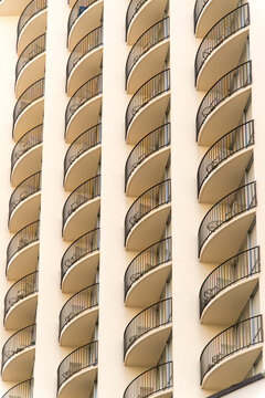 USA, Hawaii, Honolulu, Waikiki.  Repeated pattern of balconies on the outside of luxury accommodations near the beach.