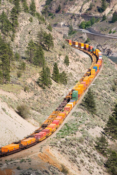 Canada, BC, Lytton.  Train carrying shipping containers in the Thompson River Canyon