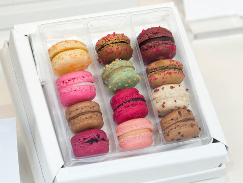 France, Paris.  A selection of macarons in take-away tray.