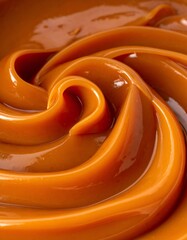 Close-up of swirling, glossy, caramel-colored dessert topping