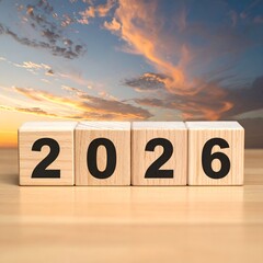 Wooden blocks spelling out the year 2026, against a sunset