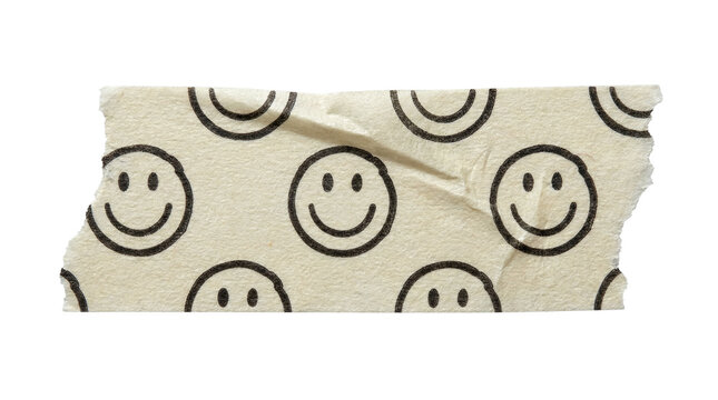 Wrinkled masking tape piece with a printed smiley face pattern, washi tape scrap on a transparent background.