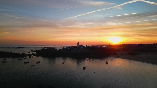 The Pontusval lighthouse, located on a rocky point in northern Finistere in Brittany,travel and landscape aerial footage at sunrise