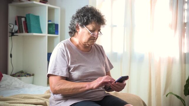 Video of a mature woman using her cell phone in her room
