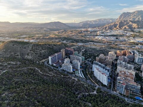 morning view of hillside housing, urban expansion observed from above on hilly terrain at sunrise