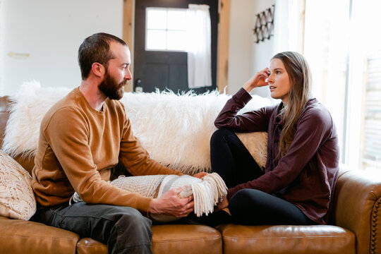 Couple Sitting and Chatting Together on a Sofa