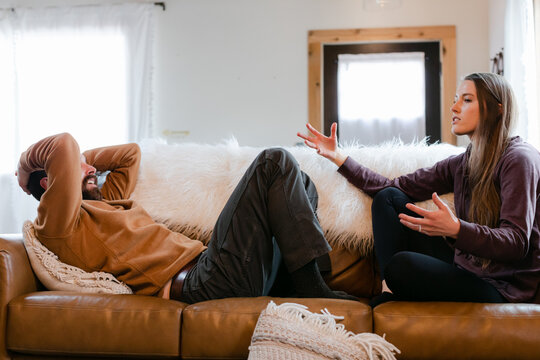 Couple Sitting on Couch and Fighting