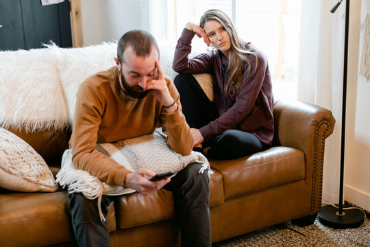 Sad, Disconnected Couple Sit Together, but Apart