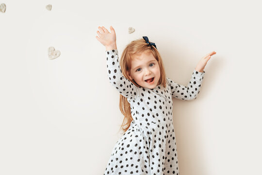 Playful little red haired girl posing for the camera