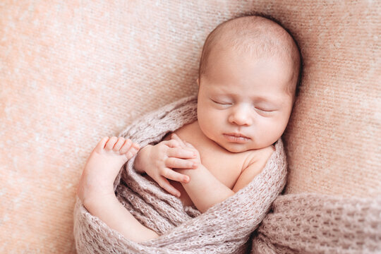Swaddled newborn baby sleeping. 