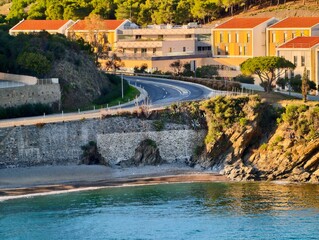 Fototapeta premium Twisting coastal pathway offering peaceful resting spots beside protected coves and green pines