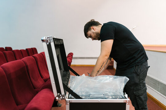Man opening custom box with electronic equipment