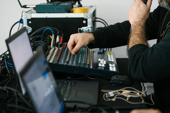 Crop man speaking on microphone and using button