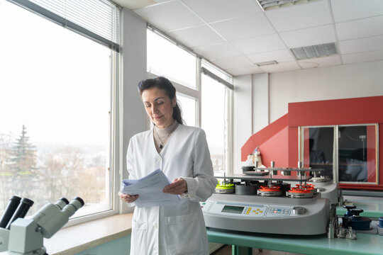 Researcher Reading Documents In The Lab