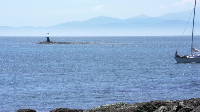 Sailboat Motoring in Sunshine Haro Strait Oak Bay 4K UHD.Sailboat motoring off Cattle Point near Victoria. British Columbia, Canada. 4K, UHD.
