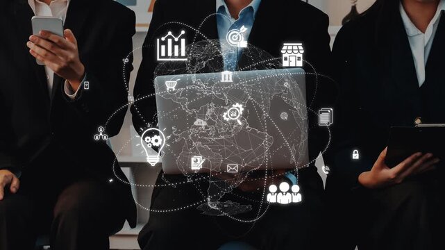 A business team collaborates with modern technology, using laptops and digital graphics to boost innovation and strategic planning in a professional setting. Raster