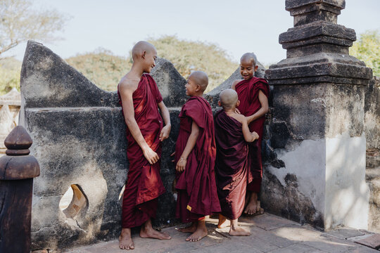 Young monks interacting in a temple courtyard