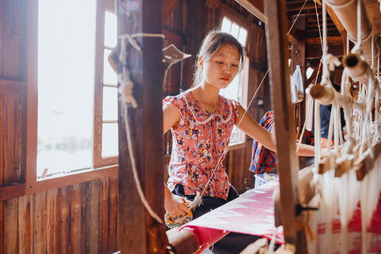 Young Woman Weaving on a Loom