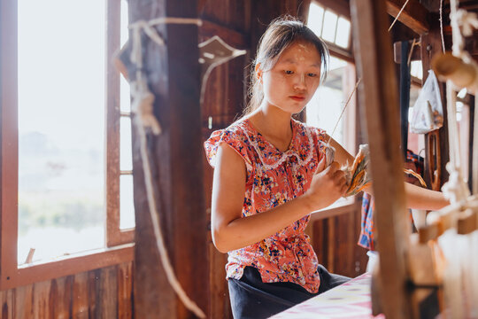Young Woman Weaving on a Loom