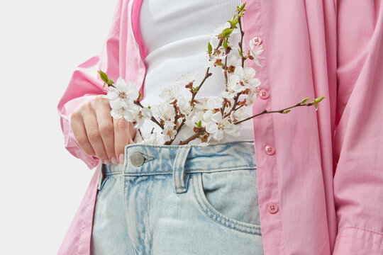 Blooming apricot sticking out waistband of denim pants