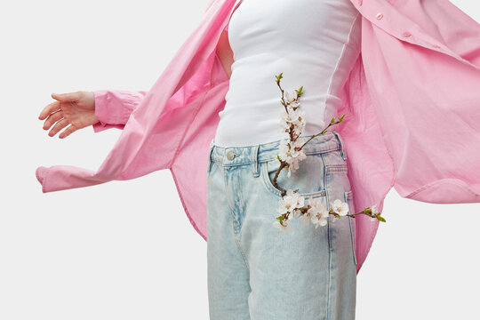 Slim female wearing pink linen shirt fluttering aside in wind