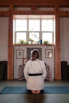 Woman meditating at alter in Aikido Dojo