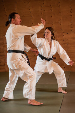Woman and Man Practie Aikido Flips
