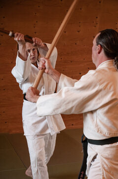 Woman and Man Practice Aikido using Swords