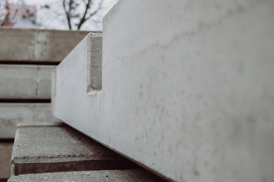 Side view of stacked prefabricated concrete elements forming a repetitive industrial structure. Precision-made precast slabs prepared for large-scale construction projects.