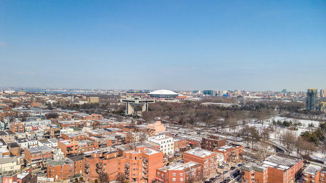 Queens, new york city, united states, showcasing a wide winter panorama of flushing meadows corona park, surrounding residential buildings, and iconic landmark structures under a clear blue sky
