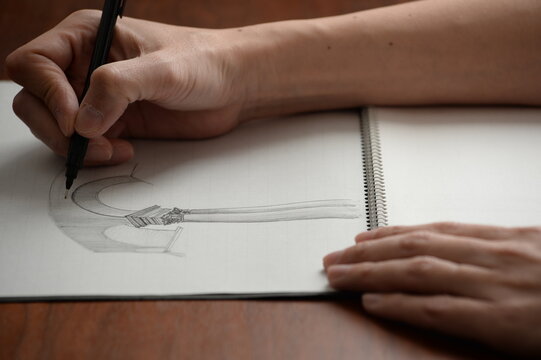 Hand drawing a sketch on white paper
白い紙にスケッチを描く手元