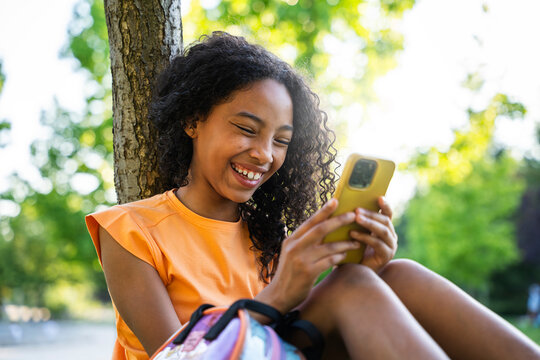 Portrait of a little girl looking at phone
