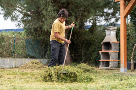 Man raking in the backyard.
