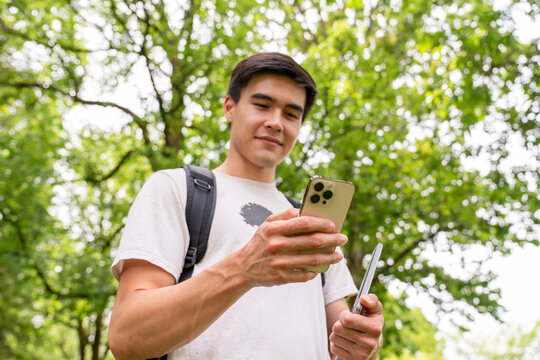 Student using cell phone outside