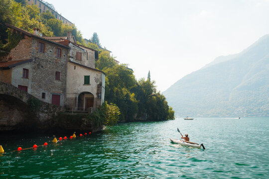 Woman on kayak on Como lake in Italy 