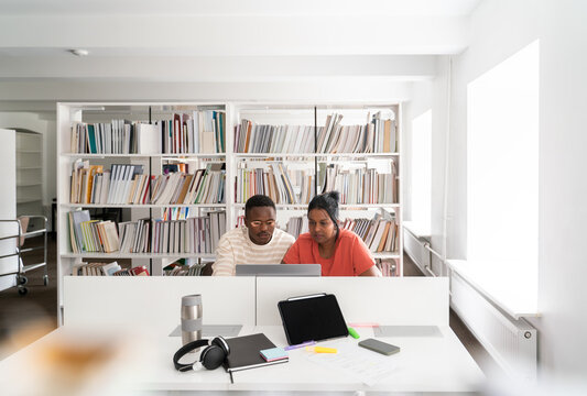 Students studying together at modern library