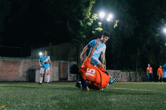 Soccer player falling after a tackle.
