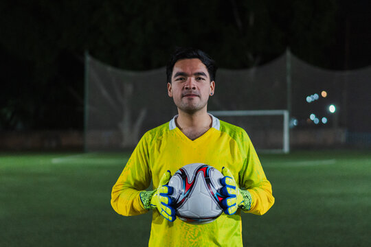 Football goalkeeper looking at the camera with pride.