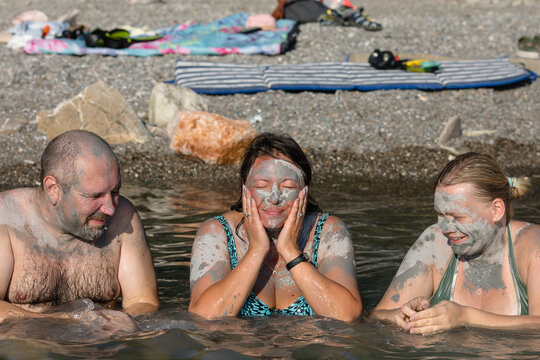 Three friends of generation x wash the clay off their faces