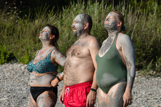 Friends enjoying natural mineral clay on the seacoast