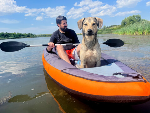 Man Kayaking with his Dog on a Sunny day