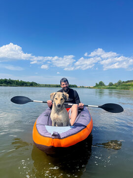 Man Enjoying Free time with his Pet Dog Outing on a Lake in Kayak