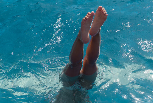 Woman Doing Handstand in a Pool