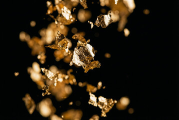 Falling gold leaves create a luxurious and minimalist design on black background