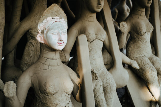 Clay sculptures of goddess being crafted in an artisan workshop