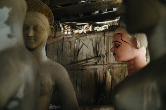 Clay sculptures of goddess being crafted in an artisan workshop