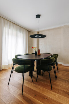 A modern dining room featuring an oval dark wood table and six chairs